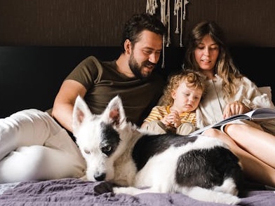 A family relaxing at home with their dog